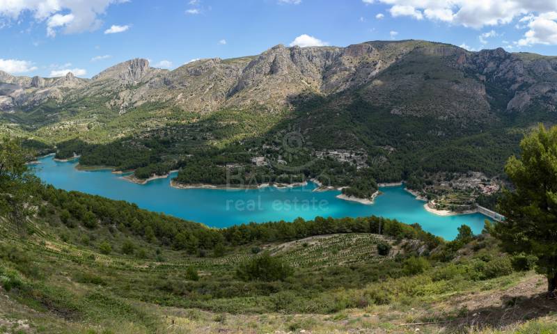 Panoramic view of the Guadalest reservoir with the Serrella mountain range in background in the province of Alicante